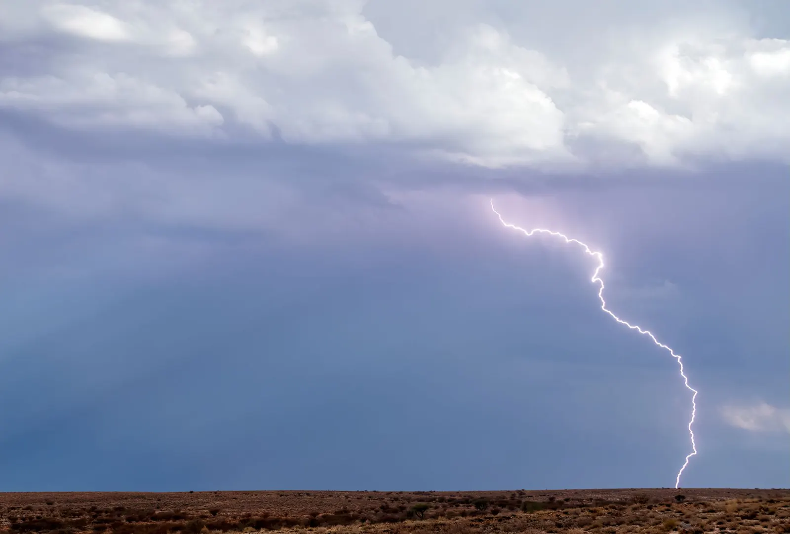 Lightning striking the desert from a storm cloud