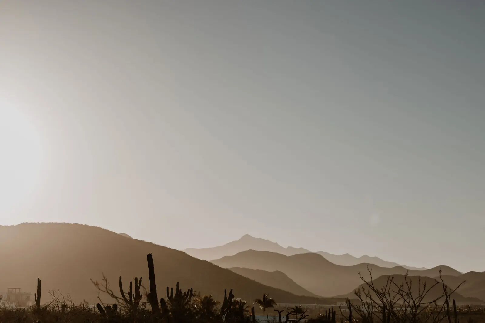 Hazy desert mountains under a bright summer sun