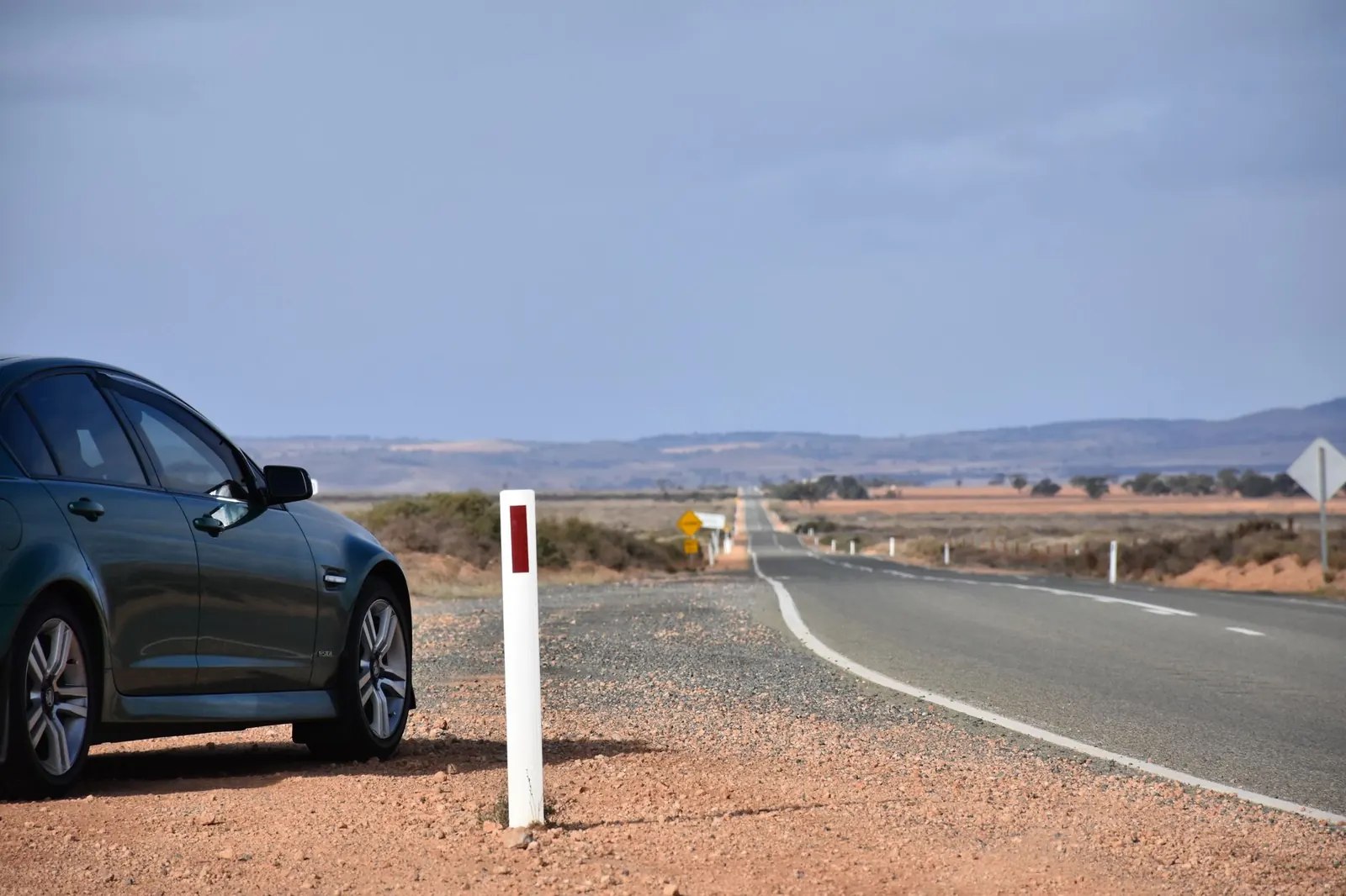 Car parked beside a desert road